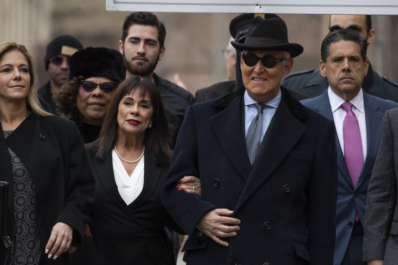 Roger Stone with accompanied by his wife Nydia Stone, second from left, arrives at federal court in Washington, Thursday, Feb. 20, 2020. Roger Stone, a staunch ally of President Donald Trump, faces sentencing Thursday on his convictions for witness tampering and lying to Congress. (AP Photo/Manuel Balce Ceneta)

