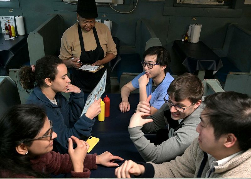 (From left) Jagdeep Kaur, Nancy Ghaleb, Daniel Trinh, Hunter Pool, and Jay Im order food from Maria Washington, co-owner of the Lassis Inn with her husband, Elihue, on Thursday, Feb. 20, 2020. The James Beard Foundation has named the Lassis Inn as one of six recipients of its 2020 America's Classics Award. The award goes to locally owned restaurants "that have timeless appeal and are beloved regionally for quality food that reflects the character of its community," according to a news release. See more photos at arkansasonline.com/221lassis/

(Arkansas Democrat-Gazette / Stephen Swofford)