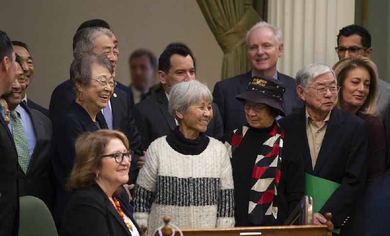 California Assemblyman Al Muratsuchi (rear, left) joins other Japanese Americans in celebrating Thursday the Assembly’s passage of a resolution apologizing to Japanese Americans incarcerated during World War II.
(AP/The Sacramento Bee/Paul Kitagaki Jr.)