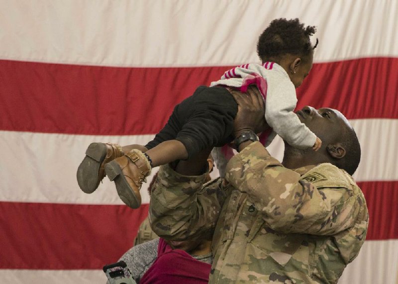 A soldier greets his daughter Thursday at Fort Bragg, N.C., as he and other members of the 82nd  Airborne Division’s Immediate Response Force begin returning from a nearly two-month deployment to the Middle East to counter a threat from Iran.
(AP/U.S. Army)