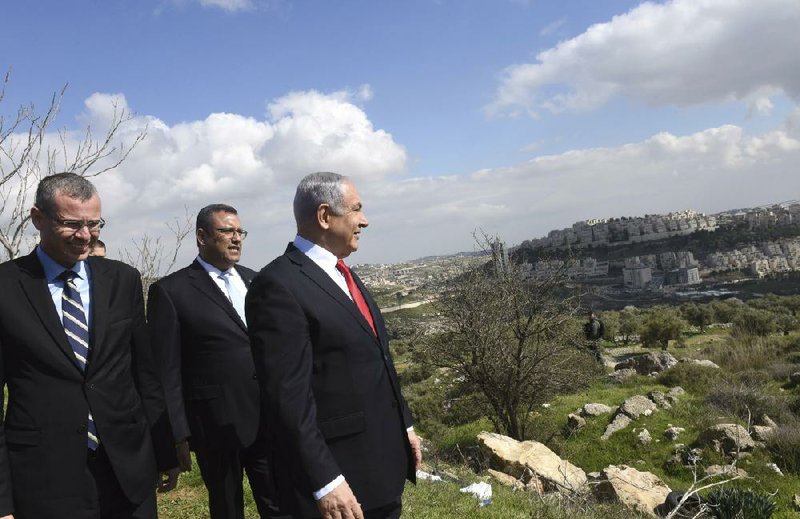 Israeli Prime Minister Benjamin Netanyahu (right) visits the Har Homa neighborhood east of Jerusalem on Thursday, one of two areas where he plans to build 5,000 new Jewish homes, a project a Palestinian official denounced as another attempt by Netanyahu “to destroy the two-state solution and any possibility of peace.”
(AP/Debbie Hill)