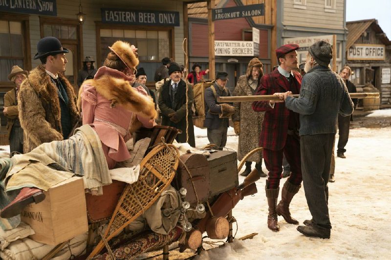 The mustachioed tenderfoot Hal (Dan Stevens) is confronted by veteran outdoorsman John Thornton (Harrison Ford) on the streets of Nome, Alaska while Hal’s sister Mercedes (Karen Gillan) and her sheepish husband Charles (Colin Woodell) look on.