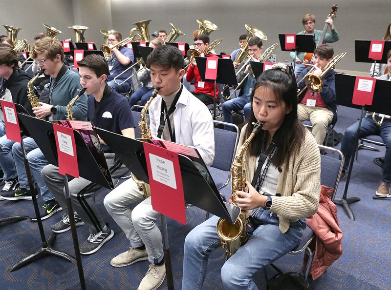 The Sentinel-Record/Richard Rasmussen From left, alto saxophone players Samual Trout, of Magnolia, Reese Dodd, of Springdale, Ethan Yang, of Russellville, and Irene Huang, of Bentonville, rehearse with the All-State Symphonic Band during the Arkansas All-State Music Conference at the Hot Springs Convention Center Thursday. The conference has around 900 student musicians and singers in attendance. The event ends Saturday.