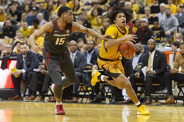 Missouri's Dru Smith, right, dribbles past Arkansas' Mason Jones, left, during the second half of an NCAA college basketball game Saturday, Feb. 8, 2020, in Columbia, Mo. Missouri beat Arkansas 83-79 in overtime. (AP Photo/L.G. Patterson)

