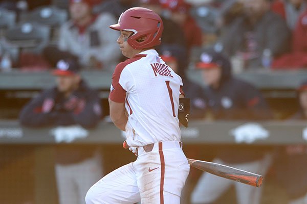 Arkansas second baseman Robert Moore slash-bunts foro a base hit Friday, Feb. 21, 2020, during the fifth inning at Baum-Walker Stadium in Fayetteville. 