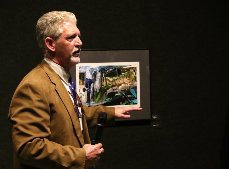 Steven Ochs, professor of art at Southern Arkansas University, talks about Paul Waschka's "Flamingo Shine" during the South Arkansas Arts Center's Viewfinder artists' awards reception Feb. 21. The exhibit will be on display through Feb. 27.    