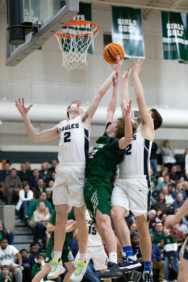 Willoughby Rusher (2) and Eli Stokes of Baptist Prep battle with Episcopal Collegiate’s Sidney Dassinger (middle) for control of a rebound Friday during the Eagles’ 50-47 victory over the Wildcats for the 3A-5 Conference tournament title.
(Arkansas Democrat-Gazette/Justin Cunningham)