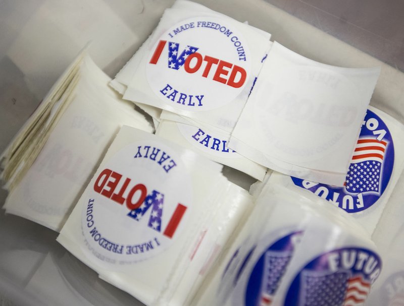 In this file photo stickers for early voters sit in a container Friday during early voting in the primary election at the Benton County clerk's office in Bentonville. 
 (NWA Democrat-Gazette/Ben Goff)