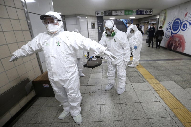 Workers wearing protective gears help clean each other's suits after disinfecting as a precaution against the coronavirus at a subway station in Seoul, South Korea, Friday. South Korea on Friday declared a "special management zone" around a southeastern city where a surging viral outbreak, largely linked to a church in Daegu, threatens to overwhelm the region's health system. - AP Photo/Ahn Young-joon