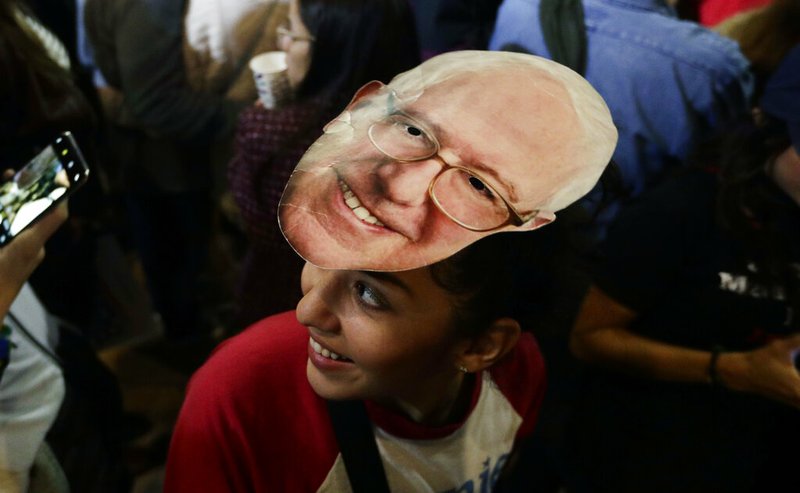 Michelle Nicoleq wears a Bernie Sanders mask as she attends a campaign event for the Vermont independent and Democratic presidential candidate in San Antonio on Saturday.