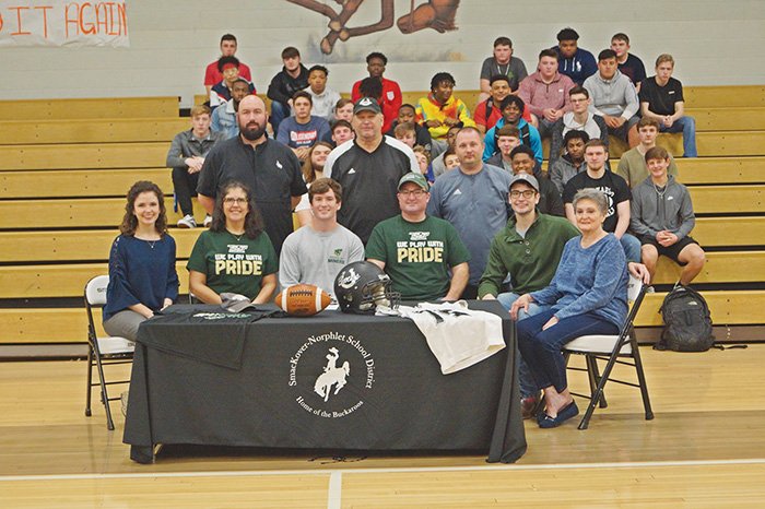 Contributed Photo Smackover’s Trevor Pyron signed to play football with Missouri University of Science and Technology. At the table from left to right are: Mallory Ballard (sister), Dana Pyron (mom), Trevor, Donald Pyron (dad), Reagan Pyron (brother) and Geneva Goad (grandmother). Coaches Tyler Kell, Brian Brown and David Osborn (standing) along with the team joined Trevor's family for the signing.
