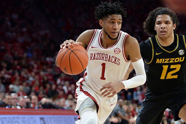 Arkansas guard Isaiah Joe (1) drives to the lane Friday, Feb. 21, 2020, as he is pressured by Missouri guard Dru Smith during the first half in Bud Walton Arena in Fayetteville. 