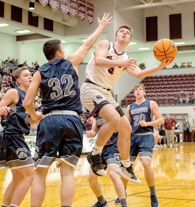 Bud Sullins/Special to Siloam Sunday Siloam Springs senior Drew Vachon drives into Greenwood traffic for a shot during Tuesday's game at Panther Activity Center.
