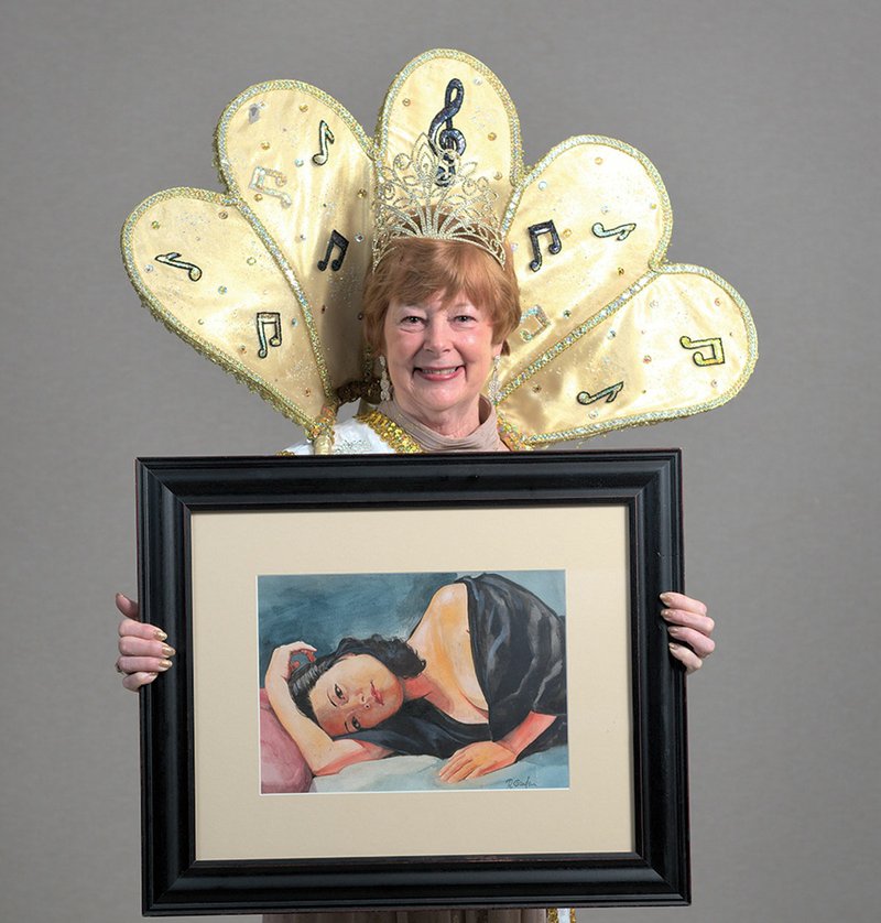 Mardi Gras Costume Ball &amp; Contest Jazz Queen VII Peggy Holt holds an original Randy Groden painting. The photograph is courtesy of Bob Dion. - Submitted photo