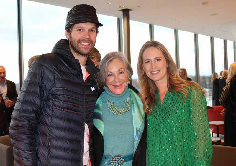 Tom and Olivia Walton, with Alice Walton (center), welcome guests to the Momentary pre-opening celebration for founding funders and other guests Feb. 20 at the new contemporary art space in Bentonville. (NWA Democrat-Gazette/Carin Schoppmeyer)