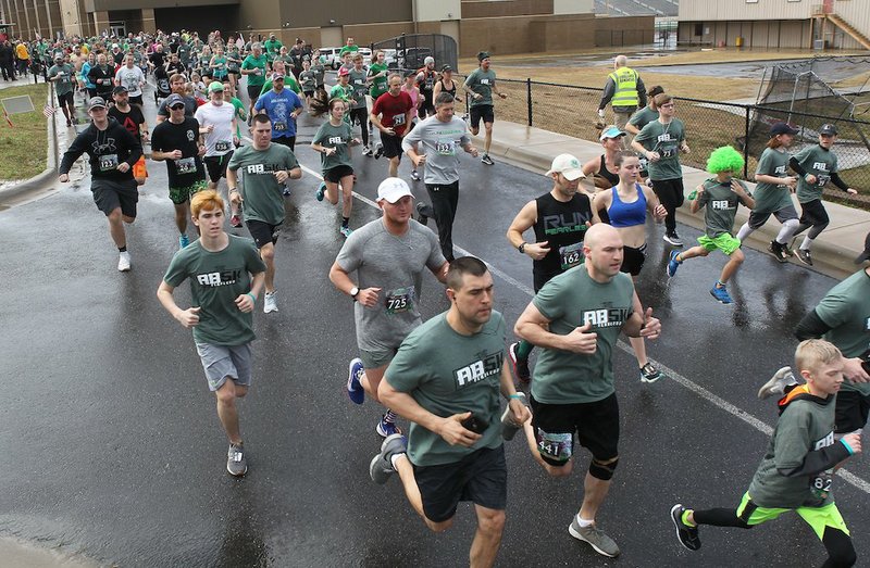 Participants take off from the starting line during the Adam Brown Shamrock Run on March 9, 2019, at Lake Hamilton School. - Photo by Richard Rasmussen of The Sentinel-Record