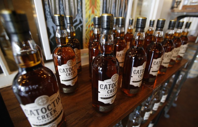 In this June 20, 2018, file photo, Catoctin Creek Distillery whiskey is on display in a tasting room in Purcellville, Va. American dairy farmers, distillers and drug makers have been eager to break into India, but it look like they'll have to wait. Indian is the world's seventh-biggest economy but it's also a tough-to-penetrate colossus of 1.3 billion people. Trade talks between the Trump administration and New Delhi were intended to forge at least a modest deal in time for President Donald Trump's visit to India that begins Monday. But the talks appear to have fizzled for now. It's important to remember that Trump and Indian Prime Minister Narendra Modi are fierce nationalists who favor protecting their own producers over opening their markets to foreign competition. - AP Photo/Steve Helber