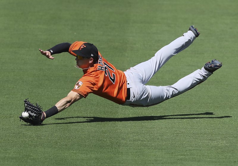 Baltimore Orioles outfielder Austin Hays can't quite get to a ball hit for an RBI single by Atlanta Braves Adam Duvall during the first inning of Saturday's game in North Port, Fla. - Photo by Curtis Compton/Atlanta Journal-Constitution via The Associated Press