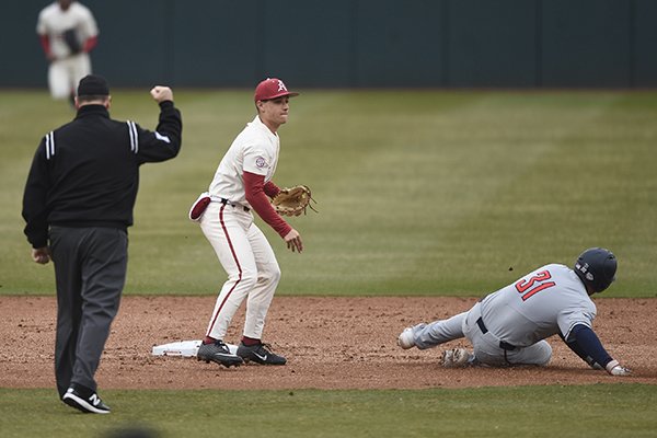 Arkansas second baseman Robert Moore throws to first base to complete a double play during the second inning of a game against Gonzaga on Sunday, Feb. 23, 2020, at Baum-Walker Stadium in Fayetteville.