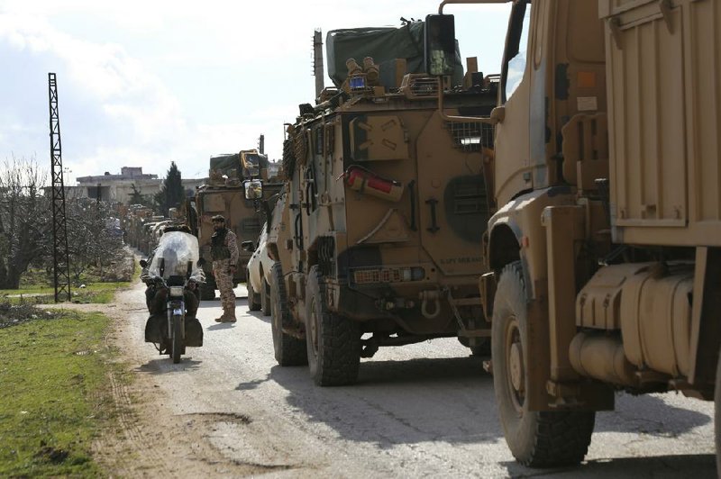 A Turkish military convoy stops Saturday in Syria’s Idlib province. Turkey has sent thousands of troops into the province in recent weeks.
(AP/Ghaith Alsayed)