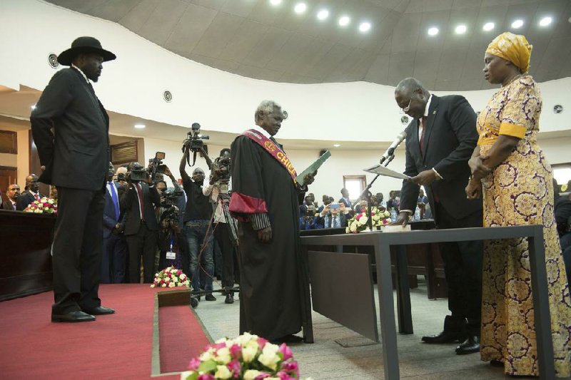 South Sudan President Salva Kiir (left) attends Saturday’s swearing-in ceremony for opposition leader Riek Machar (center right) in Juba.
(AP/Charles Atiki Lomodong)