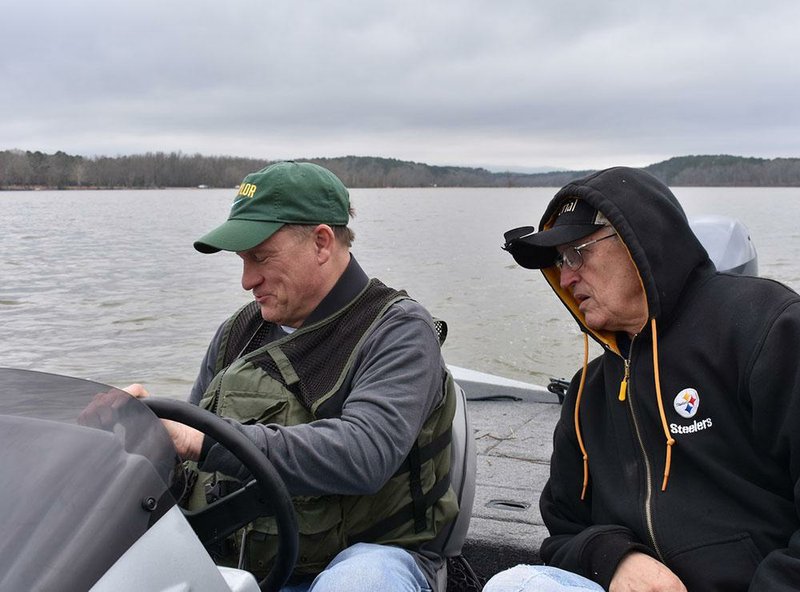 Bill Eldridge and Ed Kubler (right) look at the image of newly placed fish attractors on Eldridge’s electronic graph.
(Arkansas Democrat-Gazette/Bryan Hendricks)