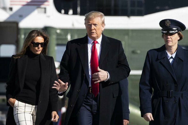 President Donald Trump, accompanied by first lady Melania Trump, waves Sunday as they walk across the tarmac to board Air Force One at Andrews Air Force Base, Md. More photos at arkansas online.com/224india/. (AP/Alex Brandon) 