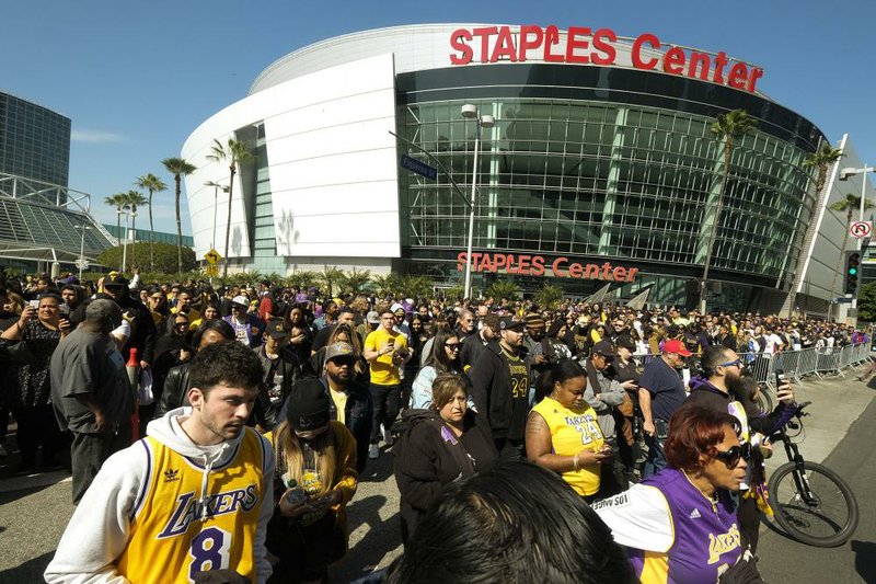 Fans leave the Staples Center in Los Angeles on Monday after a public memorial for former Lakers star Kobe Bryant and his daughter, Gianna.
(AP/Ringo H.W. Chiu)