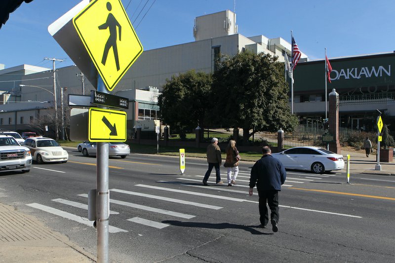 Pedestrians head across Central Avenue near Oaklawn Racing &amp; Gaming. - File photo by The Sentinel-Record