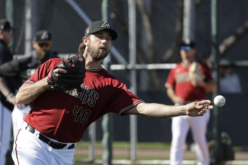 Arizona Diamondbacks' Madison Bumgarner throws during spring training baseball practice, Sunday, Feb. 16, 2020, in Scottsdale, Ariz. (AP Photo/Darron Cummings)