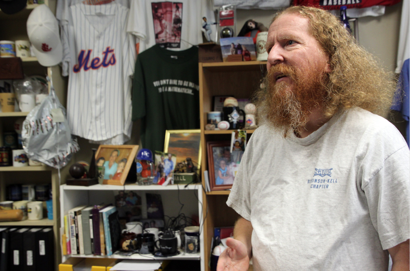 The office of Fred Worth, professor of mathematics at Henderson State University, is filled with baseball memorabilia he has collected while pursuing his hobby: Worth has visited the graves of some 7,590 baseball players. He has visited sites in every state except Alaska and Hawaii. “It’s a blast,” Worth says.
(Special to the Democrat-Gazette/Frank Fellone)
