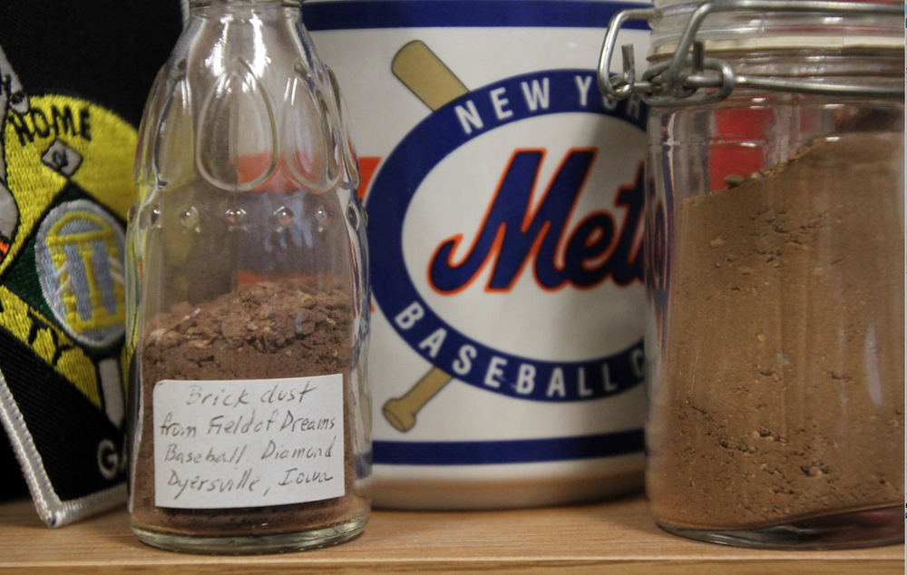 A jar on the shelf in Fred Worth’s office contains dirt from the Field of Dreams baseball diamond in Dyersville, Iowa, where the movie Field of Dreams was filmed.
(Special to the Democrat-Gazette/Frank Fellone)