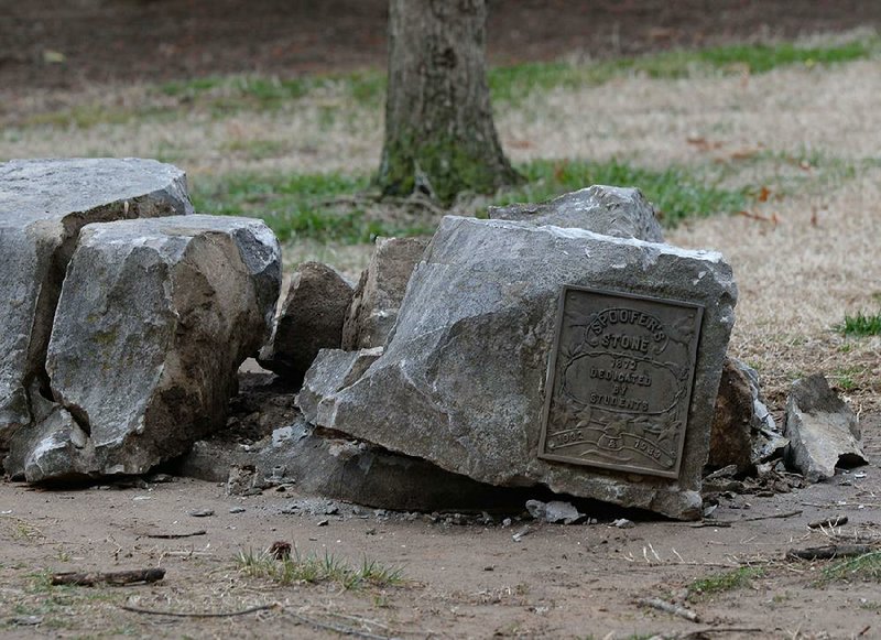 Spoofer’s Stone rests in pieces Tuesday after a construction accident east of Old Main on the University of Arkansas campus in Fayetteville. The historic stone has been a meeting place and the site for many marriage proposals over the years. 
(NWA Democrat-Gazette/Andy Shupe) 