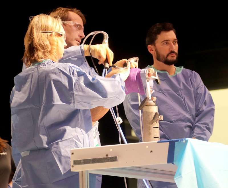 LYNN KUTTER ENTERPRISE-LEADER Dr. Andrew Heinzelmann performs surgery on a knee cadaver during a Future Health Care Providers Lab at Farmington High School.