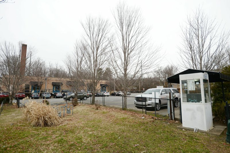 Vehicles are parked Jan. 28 in a parking lot near Arsaga's at the Depot in Fayetteville. The city and private landowners of the lot have been negotiating a deal on the location of a parking deck downtown to replace the 290 spaces lost once the Walton Arts Center parking lot becomes the civic green space of the cultural arts corridor. (File photo/NWA Democrat-Gazette/Andy Shupe)