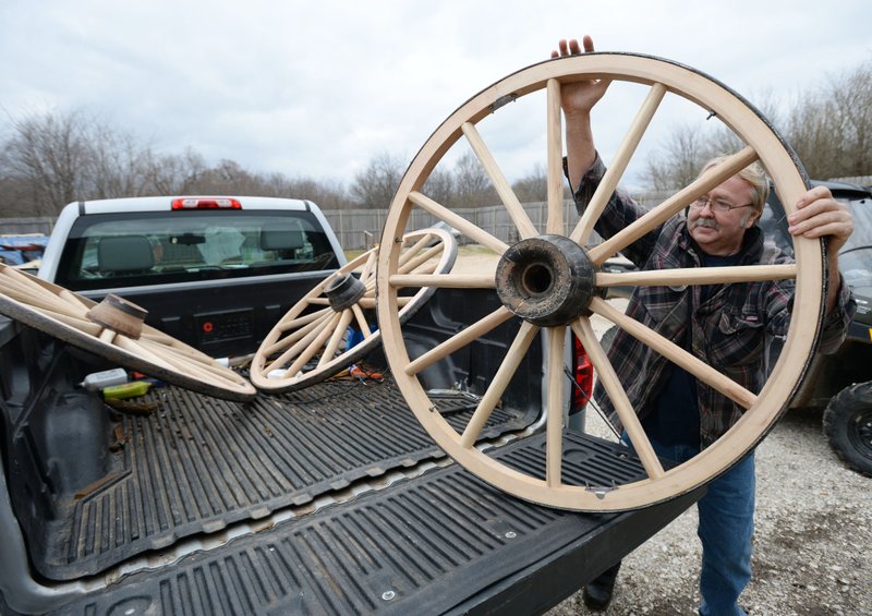 Alvin Fryar, a wheelwright and owner of a wagon restoration business in Mulberry, unloads four wagon wheels Wednesday he restored for use on a 100-year-old Springfield wagon staff at Prairie Grove Battlefield State Park is busy restoring. Fryar reconstructed one of the wagon's hubs and all but a handful of the wheels' spokes for the wagon expected to be back on display before the start of spring. Go to nwaonline.com/200227Daily/ for today's photo gallery. (NWA Democrat-Gazette/Andy Shupe)