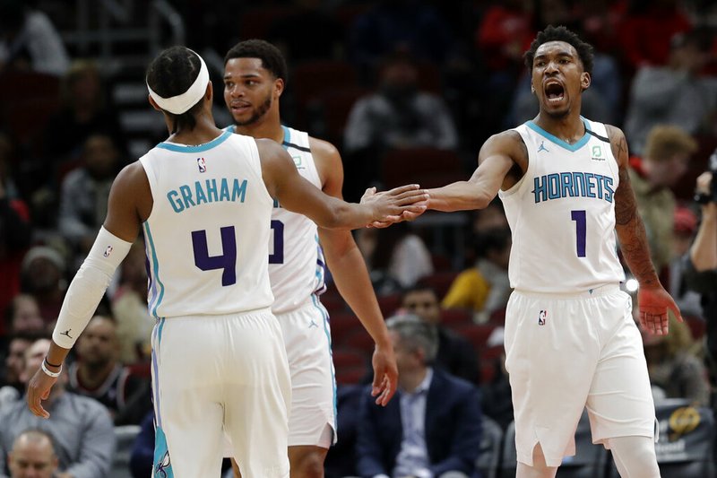 Charlotte Hornets guard Malik Monk, right, celebrates with guard Devonte' Graham (4) after scoring during the second half of the team's NBA basketball game against the Chicago Bulls in Chicago, Thursday, Feb. 20, 2020. The Hornets won 103-93. (AP Photo/Nam Y. Huh)