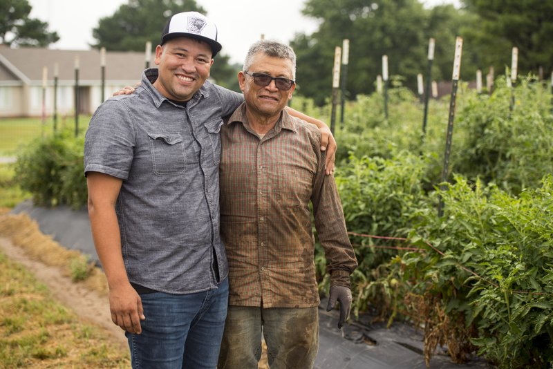 Rafael Rios (left) stands with his father, Hector Rios, at their family farm in 2017. Rafael Rios, the chef at Yeyo’s Mexican Grill in Bentonviille, was among 20 semifinalists announced Wednesday for the James Beard Awards’ Best Chef: South. (NWA Democrat-Gazette file photo/Spencer Tirey)