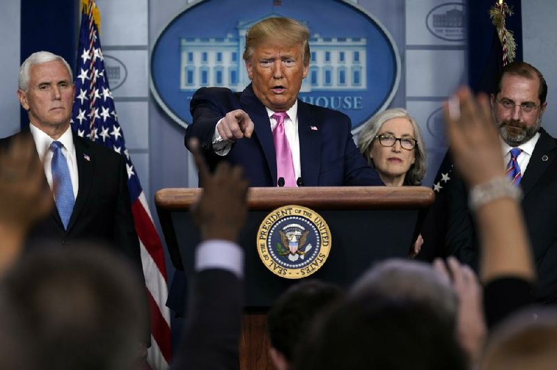 President Donald Trump holds a news conference Wednesday at the White House with health officials, including Dr. Anne Schuchat (right) of the Centers for Disease Control and Prevention. Trump sought to minimize fears of the virus after earlier criticizing cable news networks, saying they were panicking financial markets. More photos at arkansasonline.com/227virus/.
(AP/Evan Vucci)
