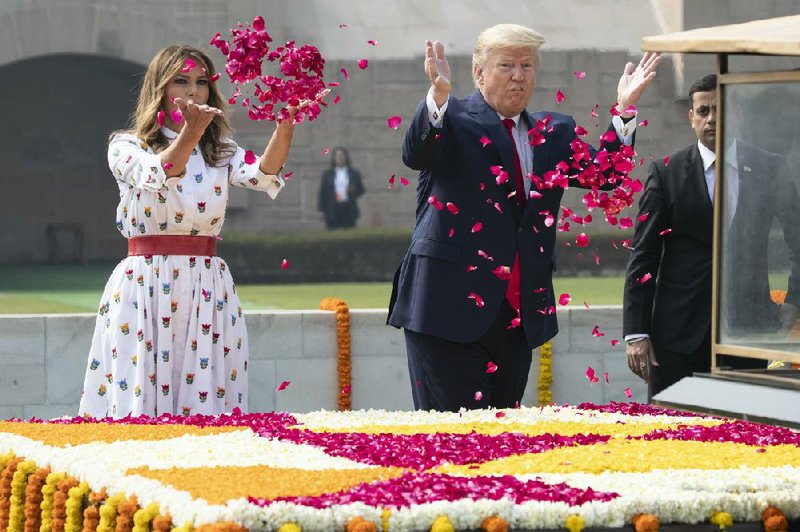 First lady Melania Trump joins President Donald Trump in lofting fl ower petals as they pay their respects Tuesday in New Delhi at the memorial to Indian independence leader Mahatma Gandhi.
(AP/Alex Brandon) (AP/Alex Brandon) 