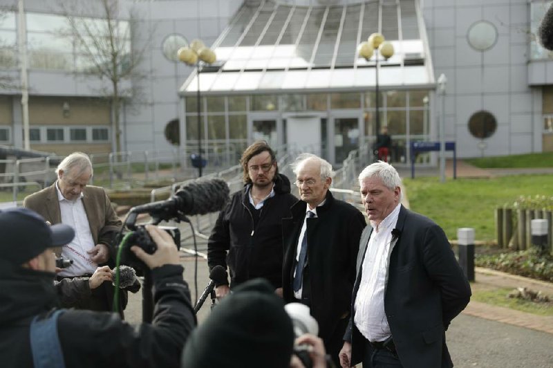 Julian Assange’s half brother Gabriel Shipton (from left) and As- sange’s father, John Shipton, listen Tuesday as editor-in-chief of WikiLeaks Kristinn Hrafnssonon speaks to the media outside Bel- marsh Magistrates’ Court in southeast London. More photos at arkansasonline.com/226assange/. 
(AP/Matt Dunham) 