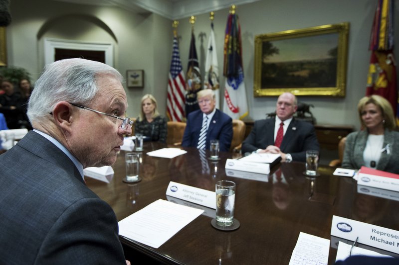 FILE - In this Tuesday, March 20, 2018 file photo, then Attorney General Jeff Sessions, left, speaks during a roundtable talks on sanctuary cities hosted by President Donald Trump, third from right, in the Roosevelt Room of the White House, in Washington. The Trump administration can withhold millions of dollars in law enforcement grants to force states to cooperate with U.S. immigration enforcement, a federal appeals court in New York ruled Wednesday, Feb. 26, 2020 in a decision that conflicted with three other federal appeals courts. (AP Photo/Manuel Balce Ceneta)