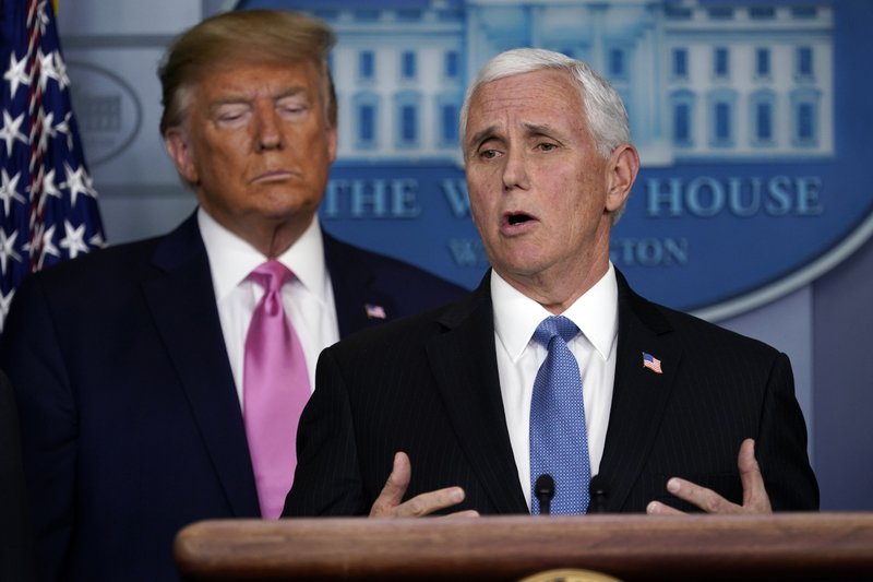 Vice President Mike Pence speaks as President Donald Trump listens during a news conference about the coronavirus in the Brady Press Briefing Room of the White House, Wednesday, Feb. 26, 2020, in Washington. (AP Photo/Evan Vucci)