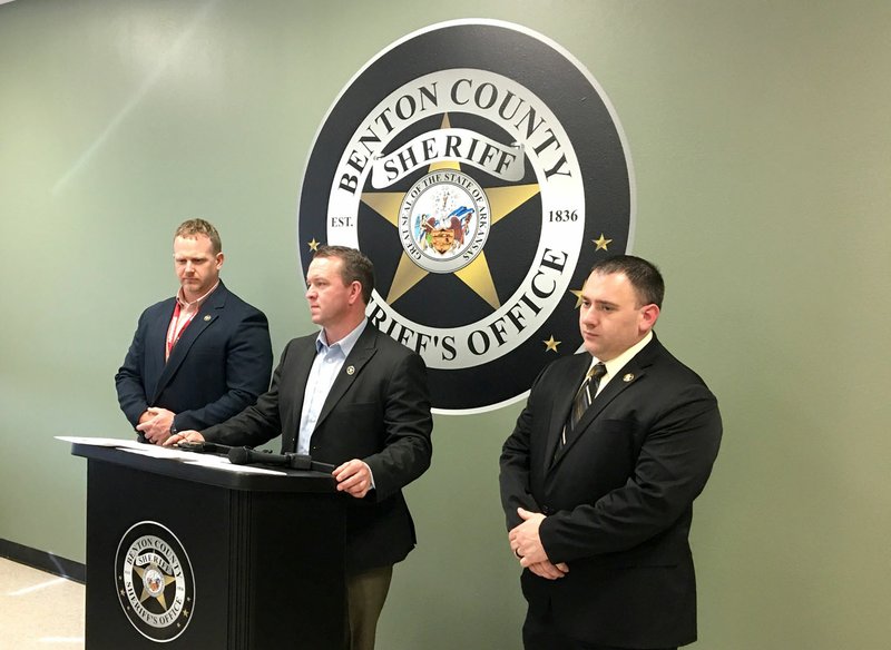 Major Kenneth Paul, Benton County Sheriff's Office Operations, (left) Sheriff Shawn Holloway (center) and Capt. Thomas See, Criminal Investigation commander, (right) speak to the media Thursday afternoon about the arrest of four people in connection with a recent homicide. (Northwest Arkansas Democrat Gazette/Mike Jones).