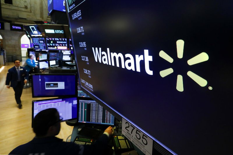 In this Feb. 18, 2020 file photo, the logo for Walmart appears above a trading post on the floor of the New York Stock Exchange. Walmart is confirming that it's developing a competitor to Amazon's juggernaut Prime membership program. The company declined on Thursday, Feb. 27 to offer details, but a spokeswoman said it will be called Walmart+. (AP Photo/Richard Drew, File)