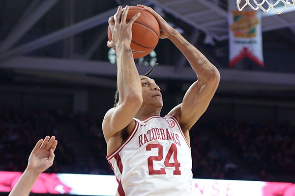 Arkansas forward Ethan Henderson (24) takes a shot in the lane Saturday, Feb. 22, 2020, over Missouri players during the second half in Bud Walton Arena in Fayetteville.