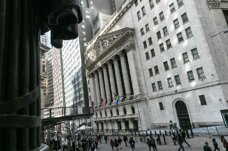 People pass by the New York Stock Exchange on Thursday where the coronavirus threat sent stocks tumbling for a fourth straight day. “Every day we think we could be near a bottom, and every day we are not,” market analyst Helane Becker wrote in a note early Thursday.
(For The New York Times/Jeenah Moon)