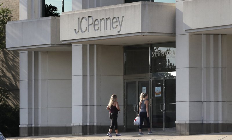 FILE - In this Aug. 14, 2019, file photo two women walk into the J.C. Penney store in Peabody, Mass. (AP Photo/Charles Krupa, File)