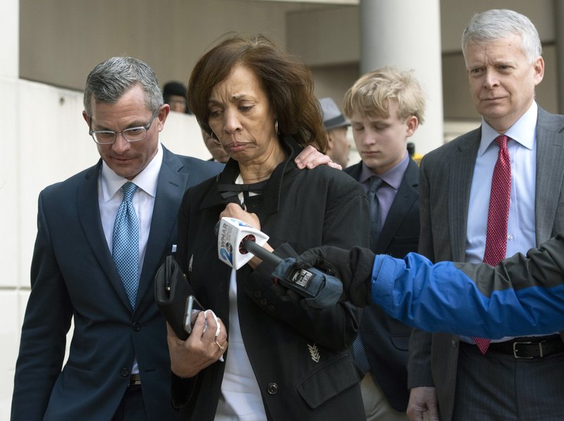 Former Baltimore mayor Catherine Pugh, second from left, and her attorney Steven Silverman, left, leave a sentencing hearing at U.S. District Court in Baltimore on Thursday, Feb. 27, 2020. Pugh was sentenced to three years in federal prison for arranging fraudulent sales of her self-published children's books to nonprofits and foundations to promote her political career. (AP Photo/Steve Ruark)