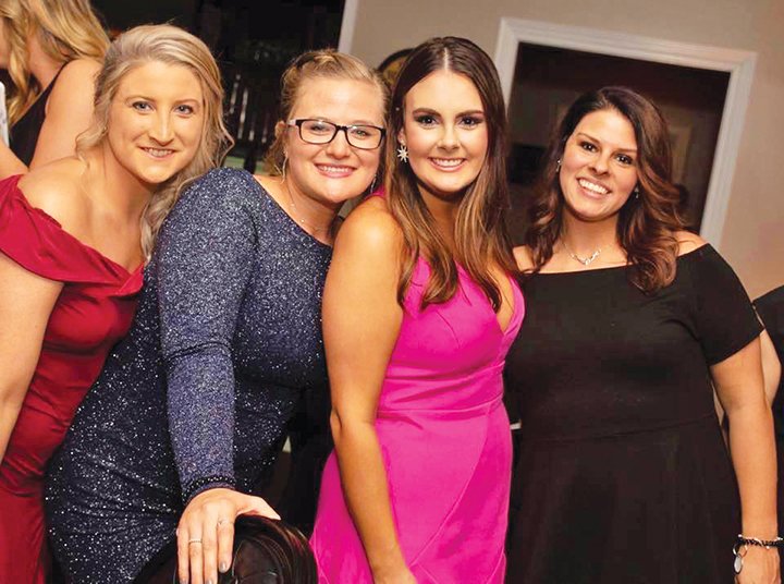 Posing for a photo at last year’s Charity Ball include Junior Auxiliary members, from left, Ashton Barnhart, Kourtney Baker, public relations chair Tessa Floyd and Megan White. This year’s ball will begin at 7 p.m. Saturday at the Searcy Country Club.